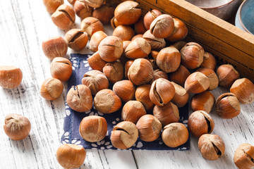 Hazelnut nuts on a white board