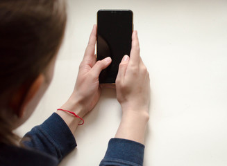 Hand holding Smartphone with blank screen on white background