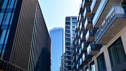 Naklejka premium Modern apartment building on a sunny day with a blue sky. Facade of a modern apartment.