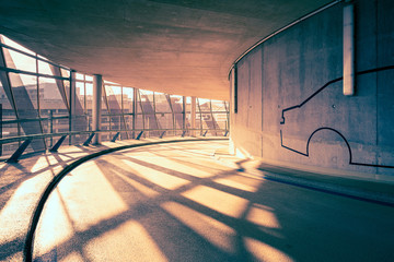 Interior driveway/corridor of a modern car park building, concrete, steel and glass construction,...