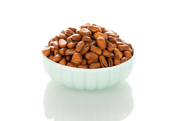 Pine nuts on a white board