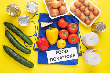 Food donations on yellow background. Food help. Top view