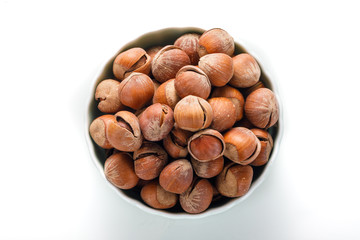 Hazelnut nuts on a white board