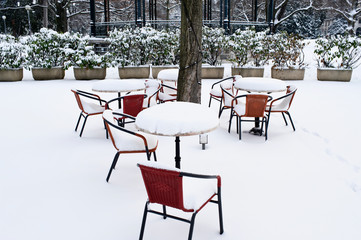 fresh snow on the terrace of a cafe in a park in Geneva Switzerland