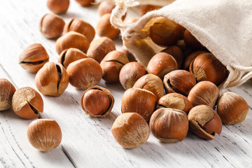 Hazelnut nuts on a white board