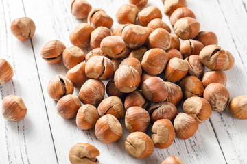 Hazelnut nuts on a white board