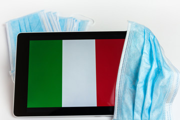Italy flag covered by surgical protective mask for coronavirus COVID-19 prevention