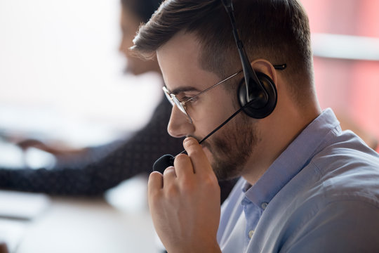 Close up call center worker side view face touch mic chatting with client use microphone give support help online, telemarketing occupation selling distantly services and products to customers concept