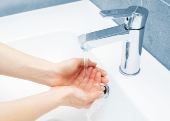 Woman use water and washing hands under the water tap