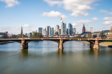 Fototapeta premium Frankfurt, Germany - March 31, 2020: frankfurt skyline view with ignas bubis bridge during daytime
