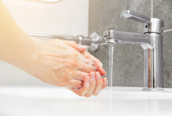 Woman use water and washing hands under the water tap