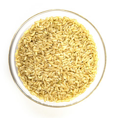 a pile of brown rice in a white bowl, isolated on a white background, top view. unpolished white rice for health. culinary dish for diabetes treatment