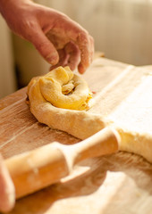 hands kneading dough croissant