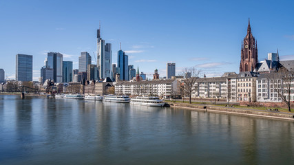 Fototapeta na wymiar Frankfurt, Germany - March 31, 2020: view on frankfurt skyline and dom from main riverside during springtime