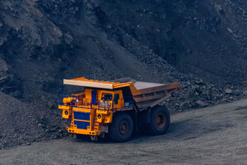 Huge empty dump truck on a gravel road in iron ore quarry