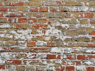 Empty old brick wall texture. Shabby building facade with damaged plaster. Copy space.