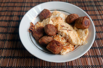 fried meatballs with egg omelet on a plate served for breakfast