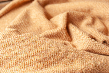 abstract background of beige knit fabric texture close up