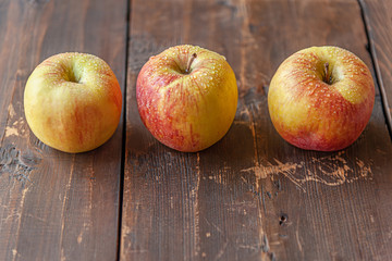 home grown sweet juicy apples on a wooden table