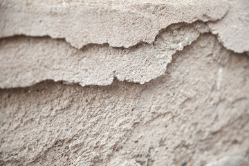 Gritty cement texture with some of it chipped off.  Broken concrete. Textured abstract background.
