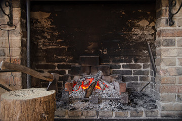 Fireplace with a burning fire, comfort and atmosphere.