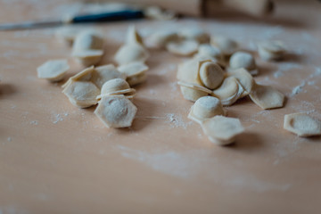 Fototapeta na wymiar Dumplings on a cutting board in the kitchen close-up.