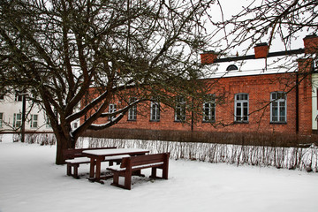 snowy landscape . old house wirh red bricks . 
