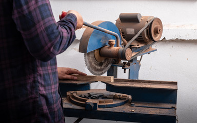 Electric circular metal saw in wood factory