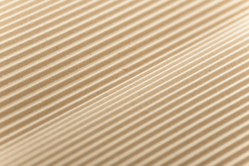 Carton or cardboard packing material. Texture of corrugated paper sheets made from cellulose. Supplies for creating boxes and packaging. Pasteboard background. Natural brown cardboard surface.