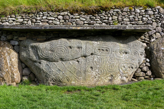 The beautifully decorated kerbstone 52 at the rear of Newgrange megalithic passage tomb in the Boyne Valley Ireland. The elaborately carved stone is directly opposite kerbstone 1 at the front entrance