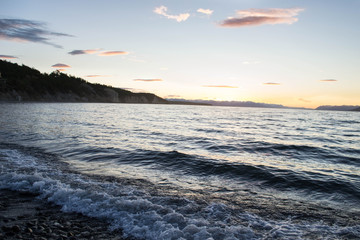 Obraz premium Atardecer en el mar con olas y acantilado
