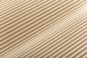 Carton or cardboard packing material. Texture of corrugated paper sheets made from cellulose. Supplies for creating boxes and packaging. Pasteboard background. Natural brown cardboard surface.