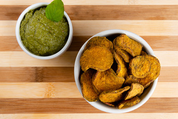Sweet potato chips on wooden background. Fast food concept. top view.