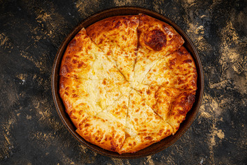 khachapuri with cheese on black background