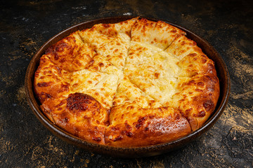 khachapuri with cheese on black background
