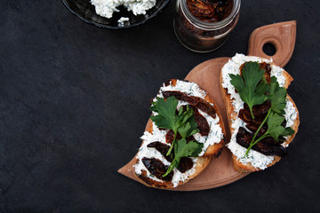 Flat lay sandwiches with croutons, cottage cheese and sun-dried tomatoes with copy space