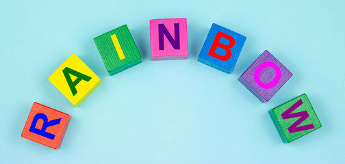 colorful wooden cubes with the inscription rainbow