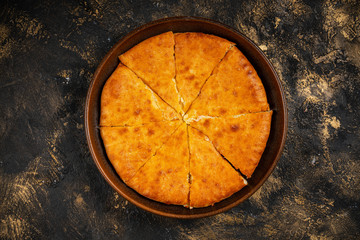 khachapuri with cheese on black background