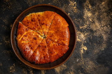 khachapuri with cheese on black background