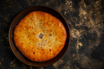 khachapuri with cheese on black background