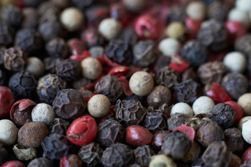 Pepper spice texture. Multicolored pepper corns, mix of colorful grains. Selective focus.