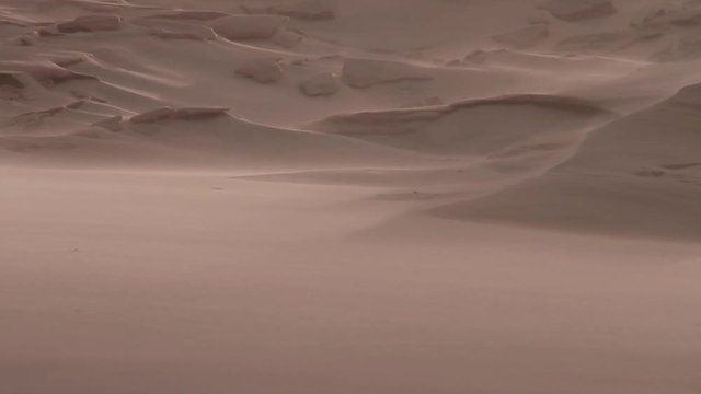 Wind blowing sand and forming geometrical forms in a dune. Telephoto lens shot (500mm) Joaquina beach. Florian&oacute;polis, Santa Catarina / Brazil