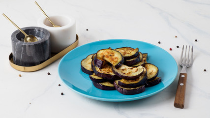 Fried eggplant in the blue plate.