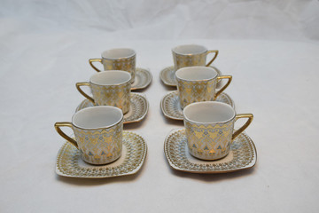 Mock up / design set of elegant and traditional teapot colorful white blue gold coffee cup & Tea cup on cup's plate beside the hot tea pot , design/ drink-ware isolated on white background