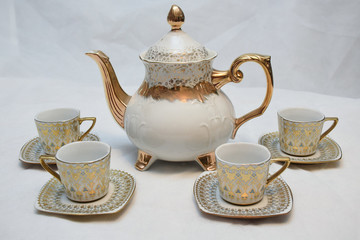 Mock up / design set of elegant and traditional teapot colorful white blue gold coffee cup & Tea cup on cup's plate beside the hot tea pot , design/ drink-ware isolated on white background