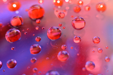 shiny clear water point attached to a glass reflects the same color as the color on the glass into a beautiful background as decoration