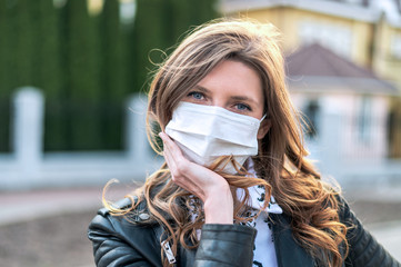 Virus mask. COVID-19. Woman walking in public space wearing face protection in prevention for...