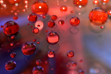 shiny clear water point attached to a glass reflects the same color as the color on the glass into a beautiful background as decoration