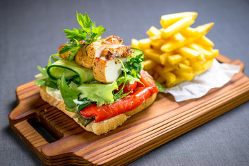 Grilled chicken breast on a toast with tomatoes