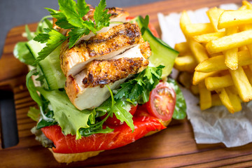 Grilled chicken breast on a toast with tomatoes